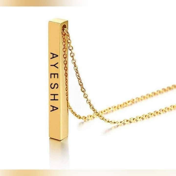Two customizable bar necklaces from Muhva Store, featuring sleek metal designs, displayed on a neutral background.