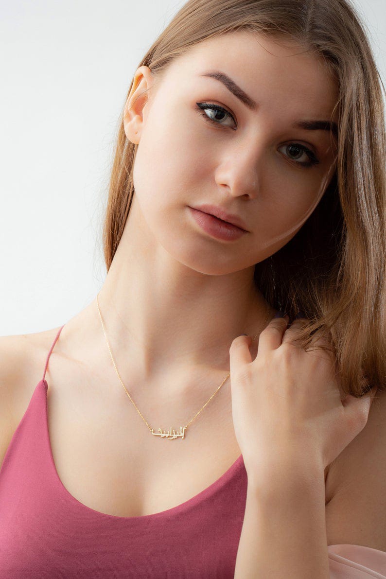 Personalized name necklace from Muhva Store featuring a custom engraved pendant on a delicate chain.