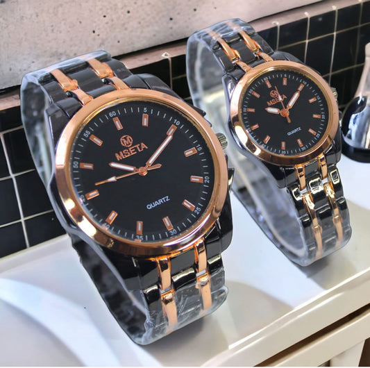 Muhva Store MSETA Couple Watch M-003 with matching silver-tone bands and round watch faces on a white background.