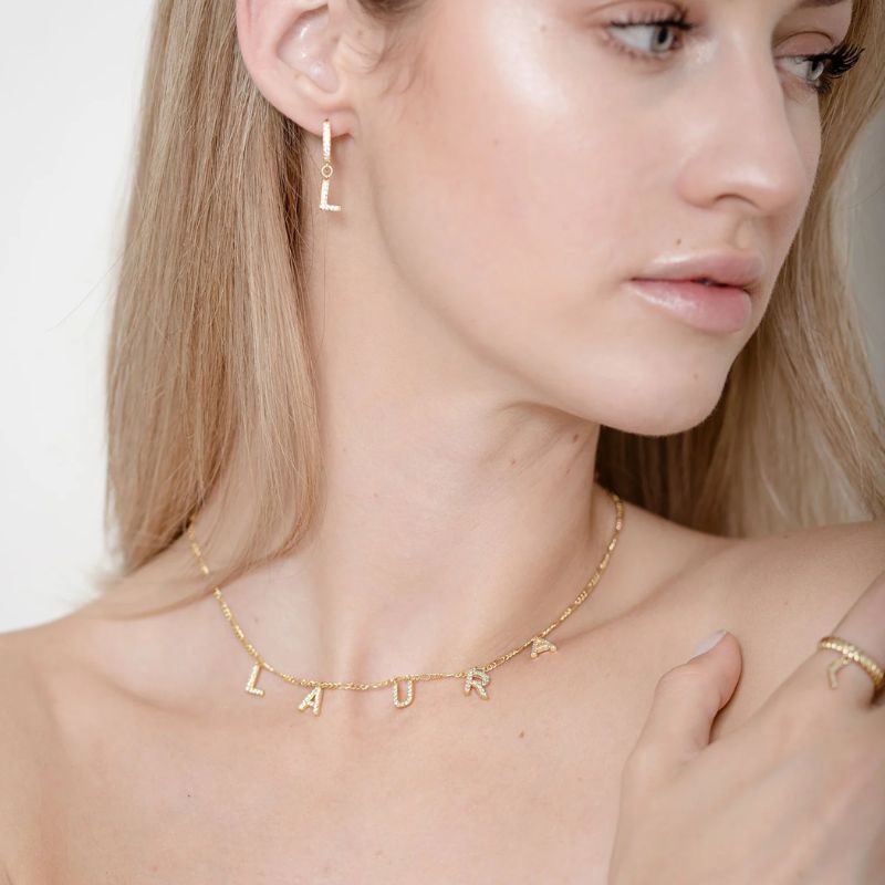 Letter necklace and bracelet set from MUHVA STORE featuring gold-toned jewelry with letter pendants and matching bracelet.