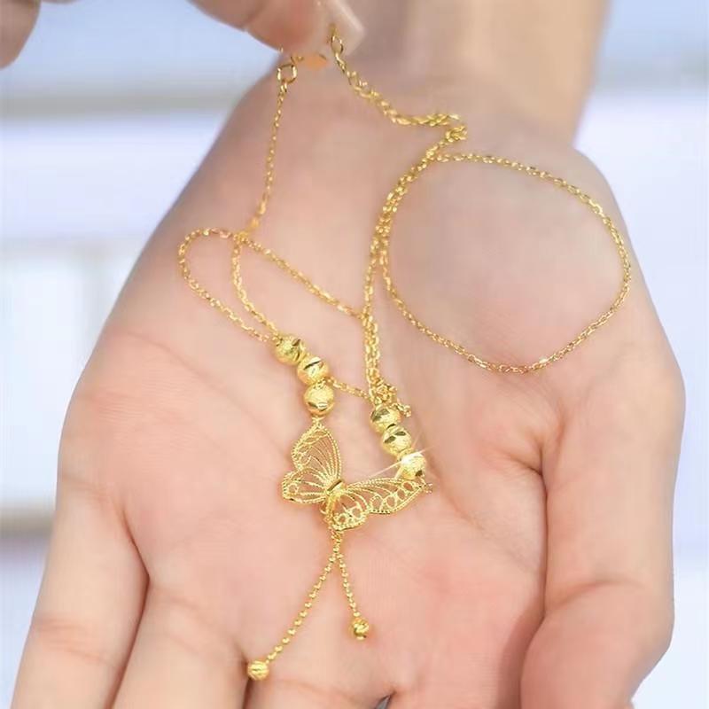 Two butterfly design necklaces by MUHVA STORE displayed on a plain background, showing delicate butterfly pendants on chain necklaces.