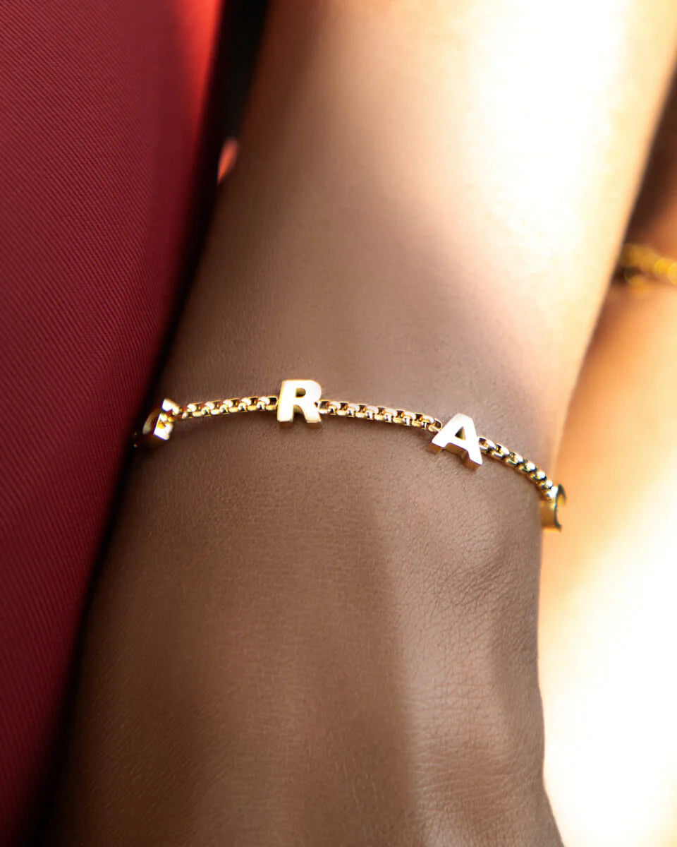 Gold-coated Stacy name bracelet by Muhva Store featuring a personalized engraved name on a sleek, stylish jewelry piece.