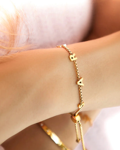 Gold-coated Stacy name bracelet from MUHVA STORE featuring a personalized engraved name on a sleek, stylish bracelet.