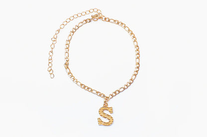 Silver initial anklet by Muhva Store featuring delicate chain and letter charm, perfect for stylish ankle jewelry.