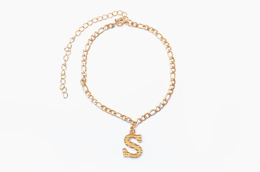 Silver initial anklet by Muhva Store featuring delicate chain and letter charm, perfect for stylish ankle jewelry.