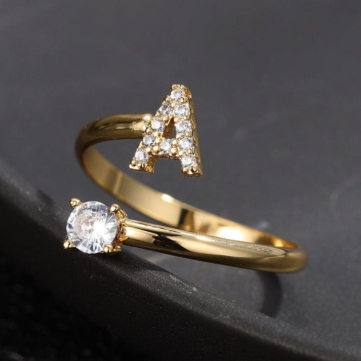 Pair of gold initial letter rings from MUHVA STORE, featuring bold letter R designs in a sleek, minimalist style.
