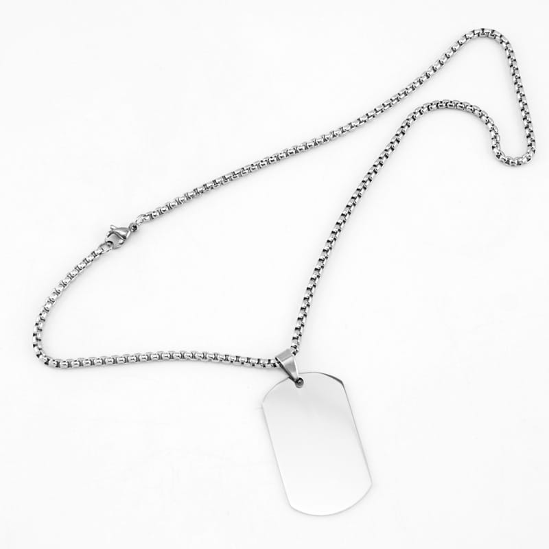 Two silver customized pendants with engraved designs, displayed on a neutral background, showcasing the classic jewelry style.