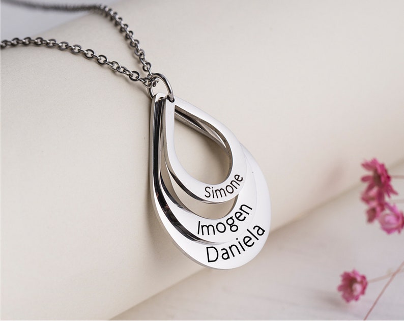 Customized drop necklace with three name pendants by MUHVA STORE, featuring personalized silver jewelry on a delicate chain.