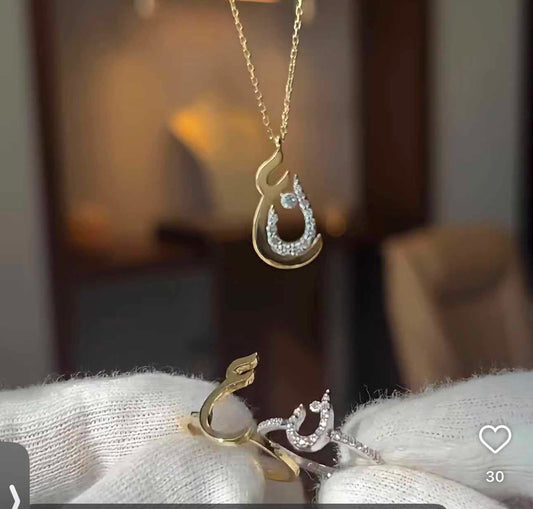 Arabic initials necklace and rings set featuring gold-tone jewelry with intricate Arabic script designs.