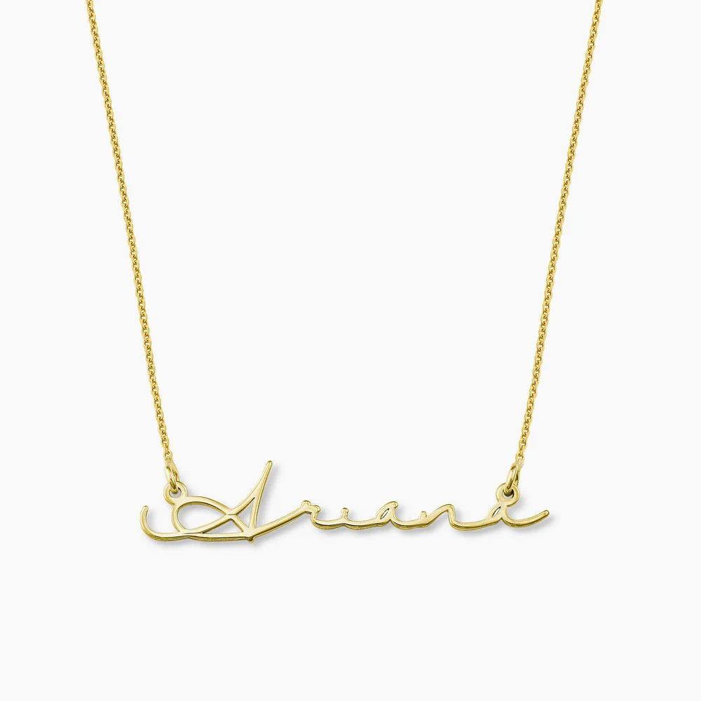 Gold plated signature name necklace from MUHVA STORE, featuring a personalized name pendant on a delicate chain.
